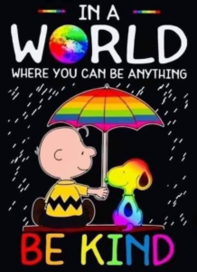 In a world where you can be anything be kind text with a picture of snoopy the dog and Charlie Brown under a rainbow umbrella